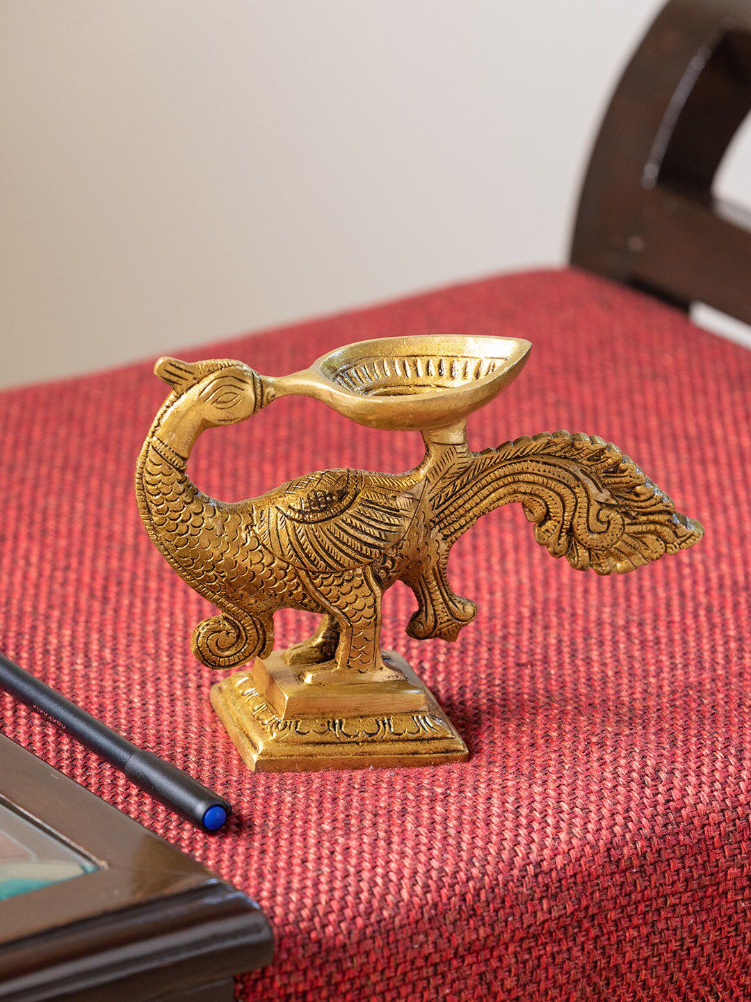 ExclusiveLane Gold-Toned Gleaming Peacock Hand-Etched Carved Diya Price in India