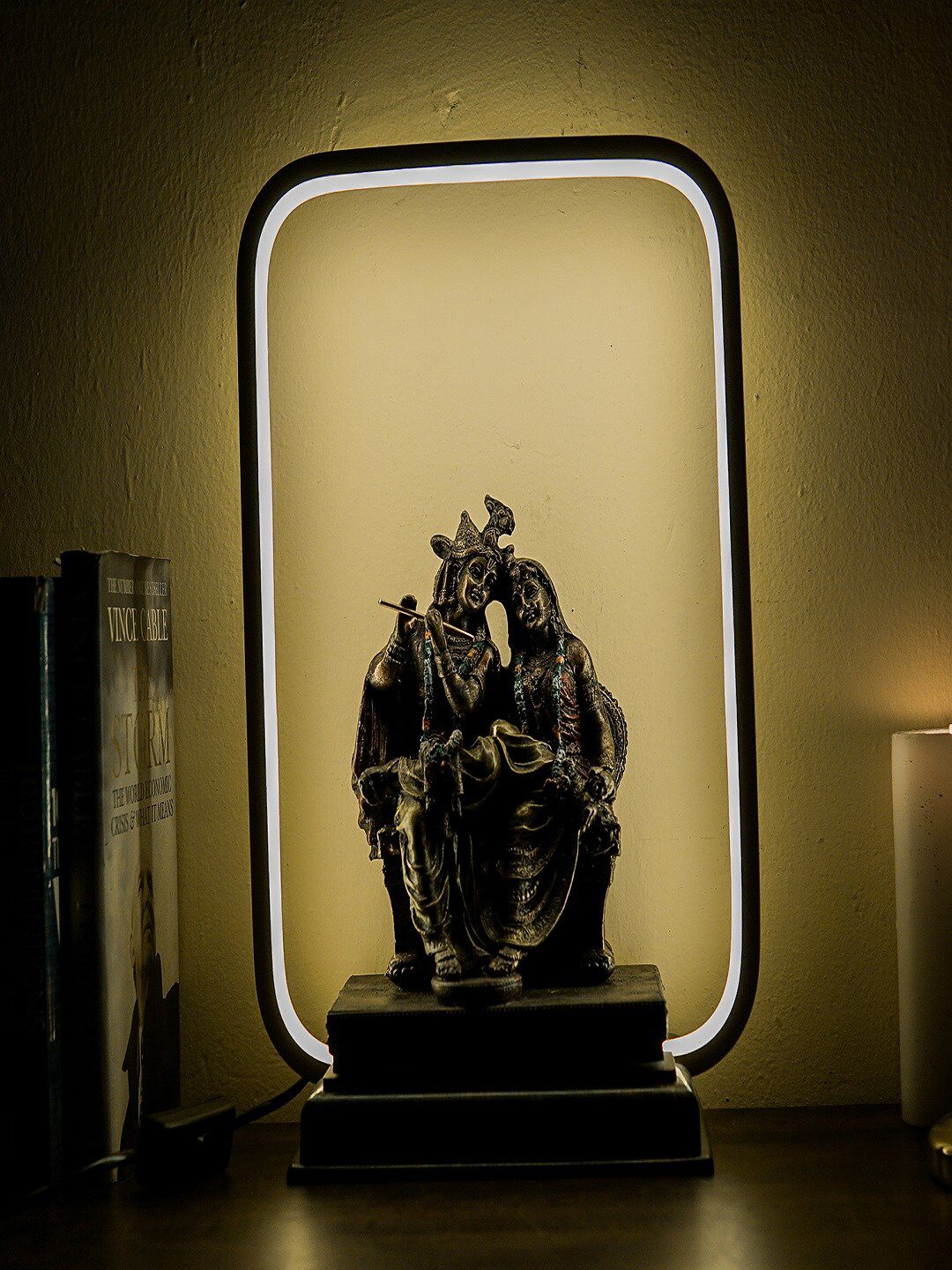 StatueStudio Black & Metallic-Toned Textured Radha Krishna Idol With LED Frame Showpiece Price in India