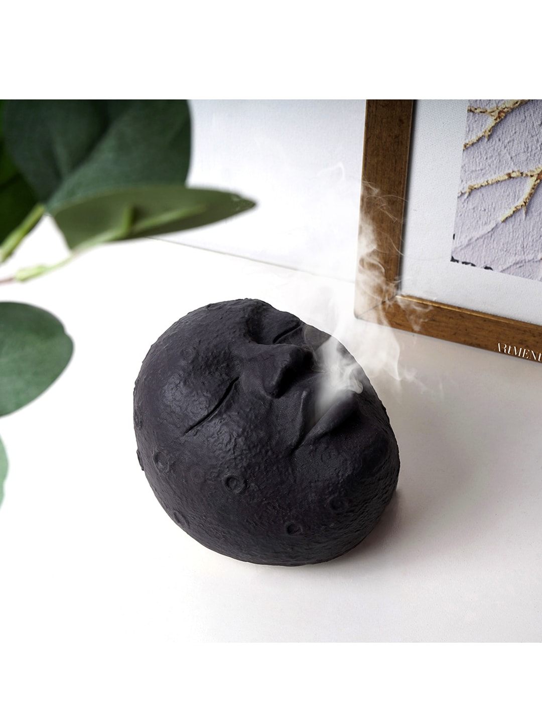 THE ARTMENT Black Textured Resting Face Incense Holder Showpiece Price in India