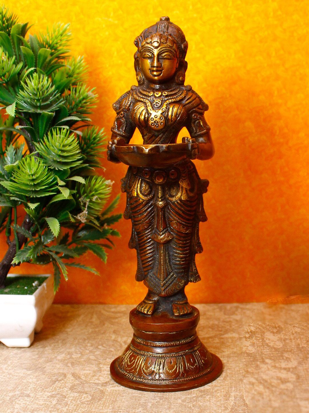 StatueStudio Copper-Toned & Orange Textured Standing Deep Lady Deeplakshmi Idol Showpiece Price in India