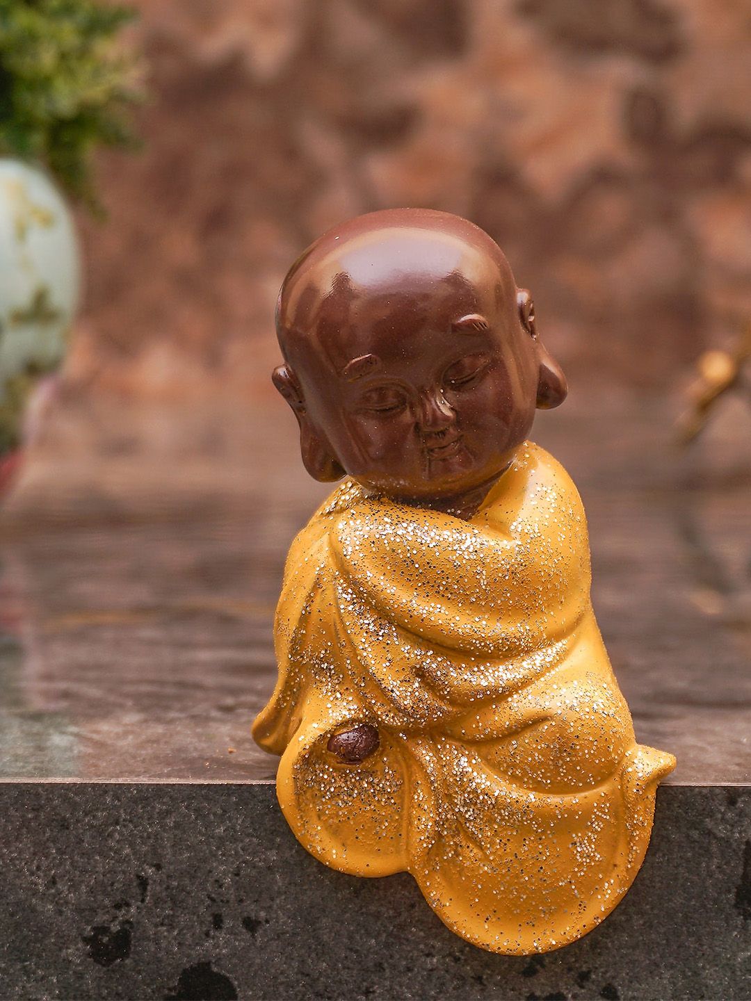 StatueStudio Yellow & Brown Decorative Monk Buddha Showpiece Price in India
