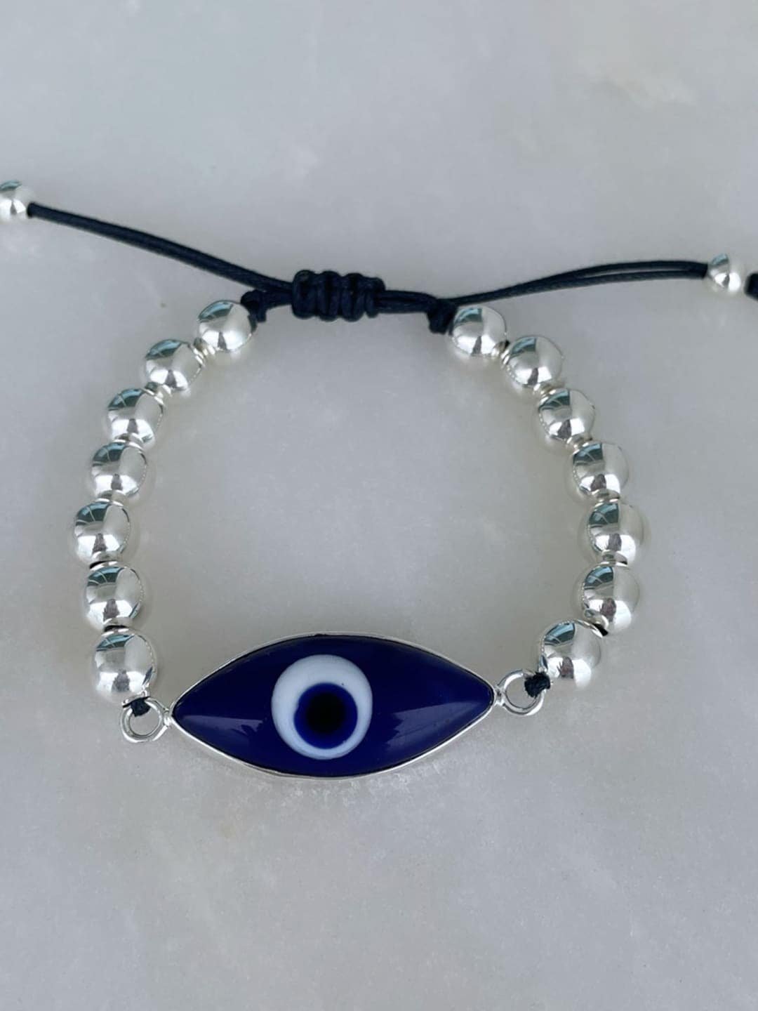 MNSH Women Silver-Toned & Blue Brass Wraparound Evil Eye Bracelet Price in India