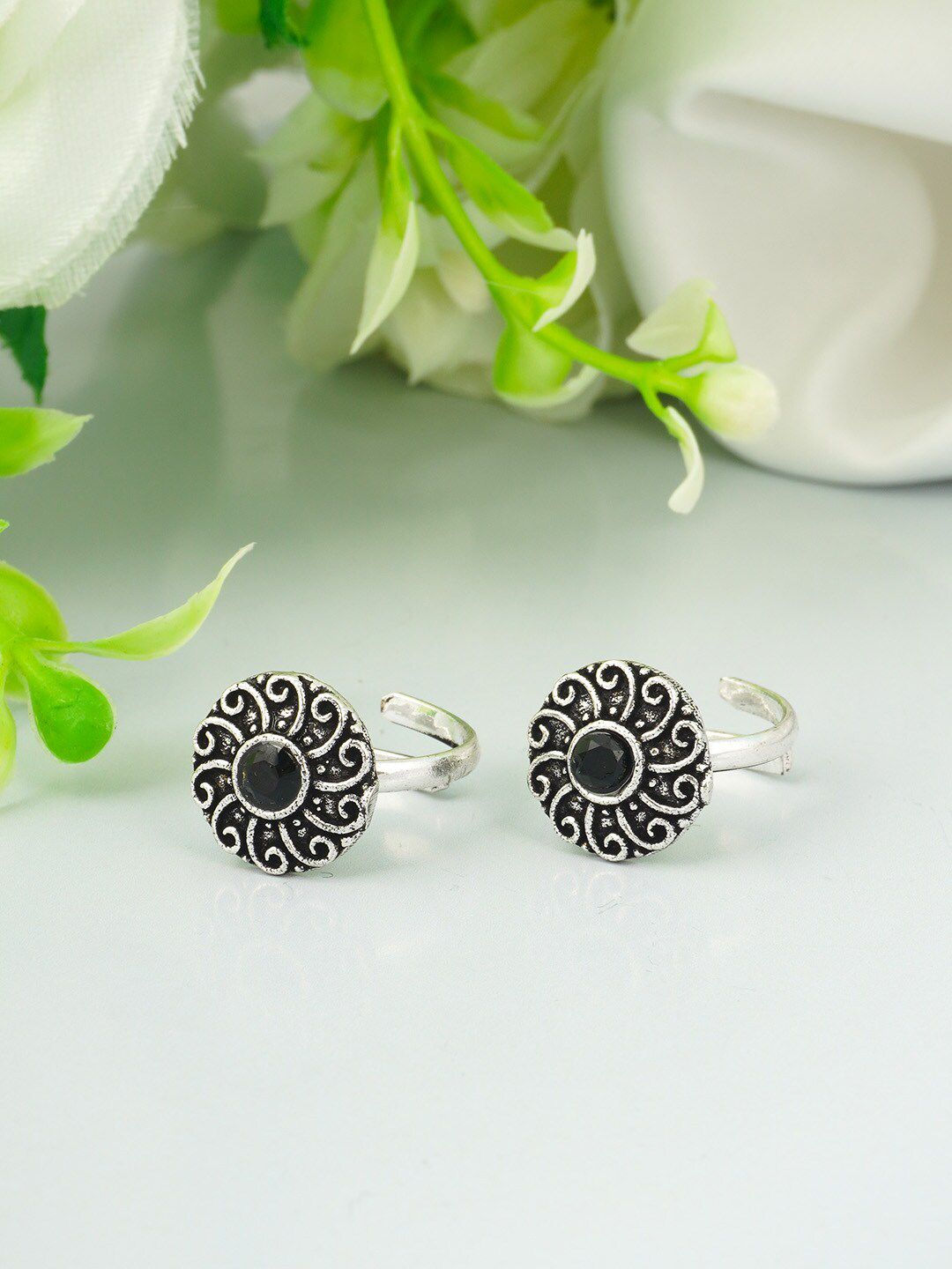 Urmika Silver Plated & Black Floral Oxidised Toe Rings Price in India