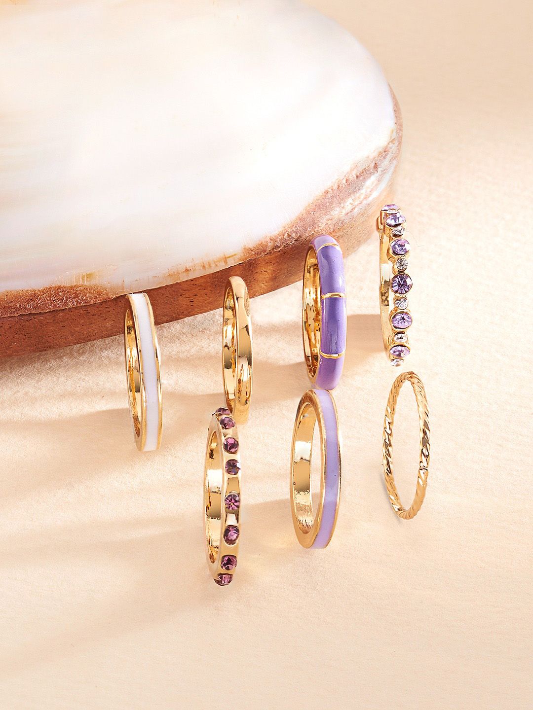 Zaveri Pearls Set of 7 Gold-Plated Purple Stone Studded Contemporary Stackable Rings Price in India