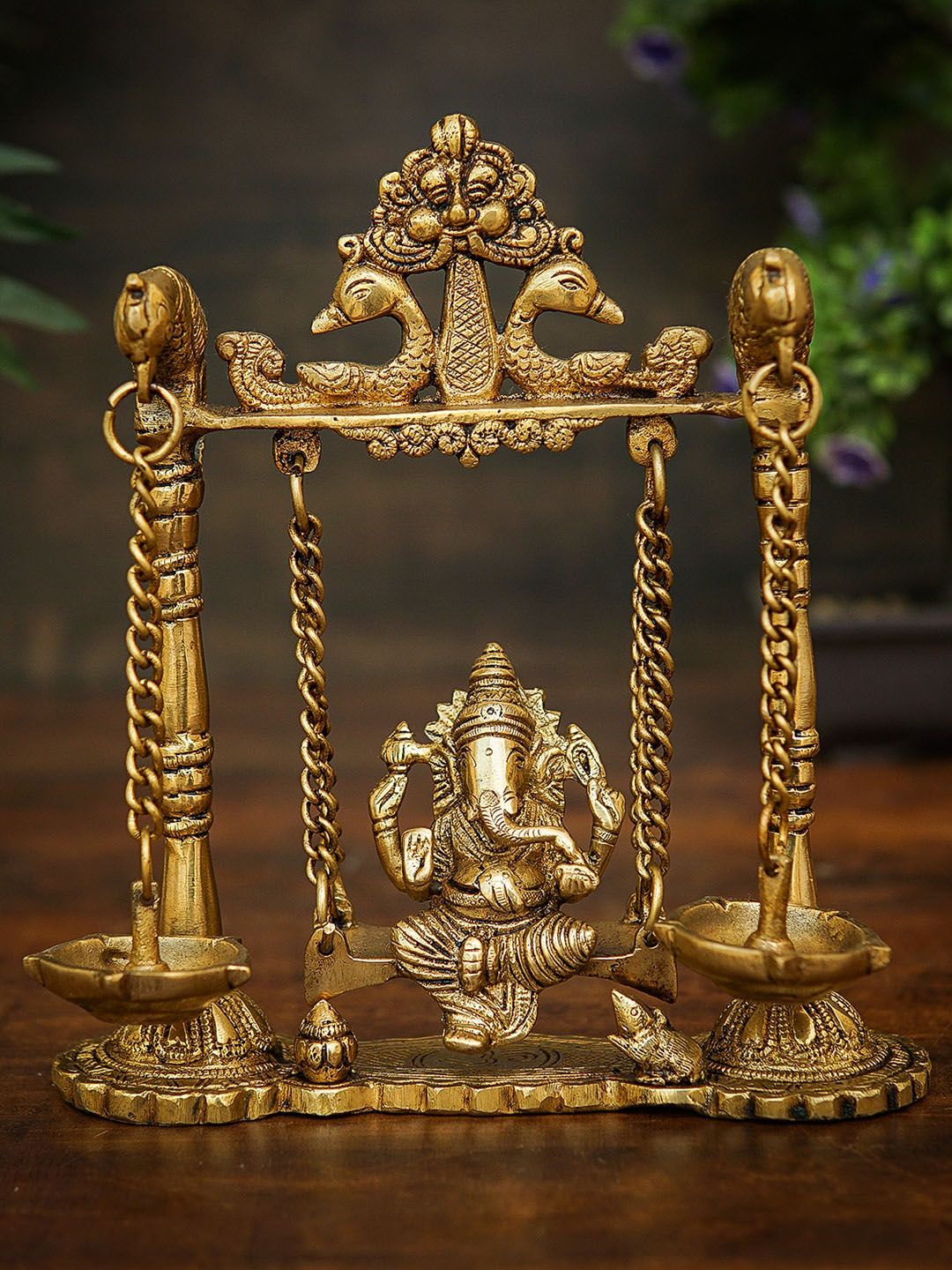 StatueStudio Gold Toned Ganesha Idol On Jhula Swing Brass Showpieces Price in India