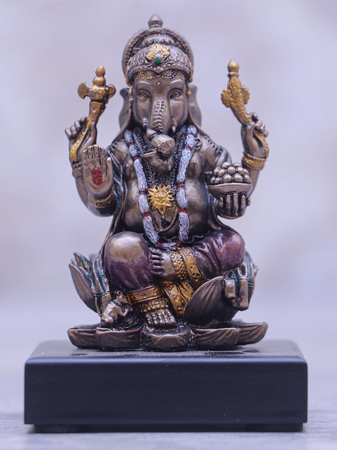 StatueStudio Metallic-Toned Textured Ganesha Statue Sitting On Base Showpiece Price in India