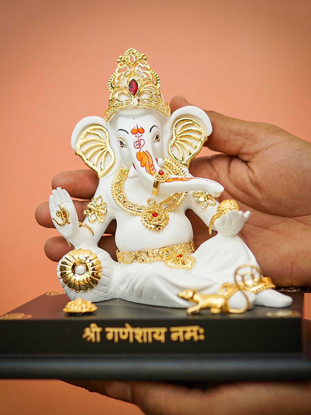 StatueStudio White & Gold-Toned Textured Reclining Ganesha Showpiece Price in India
