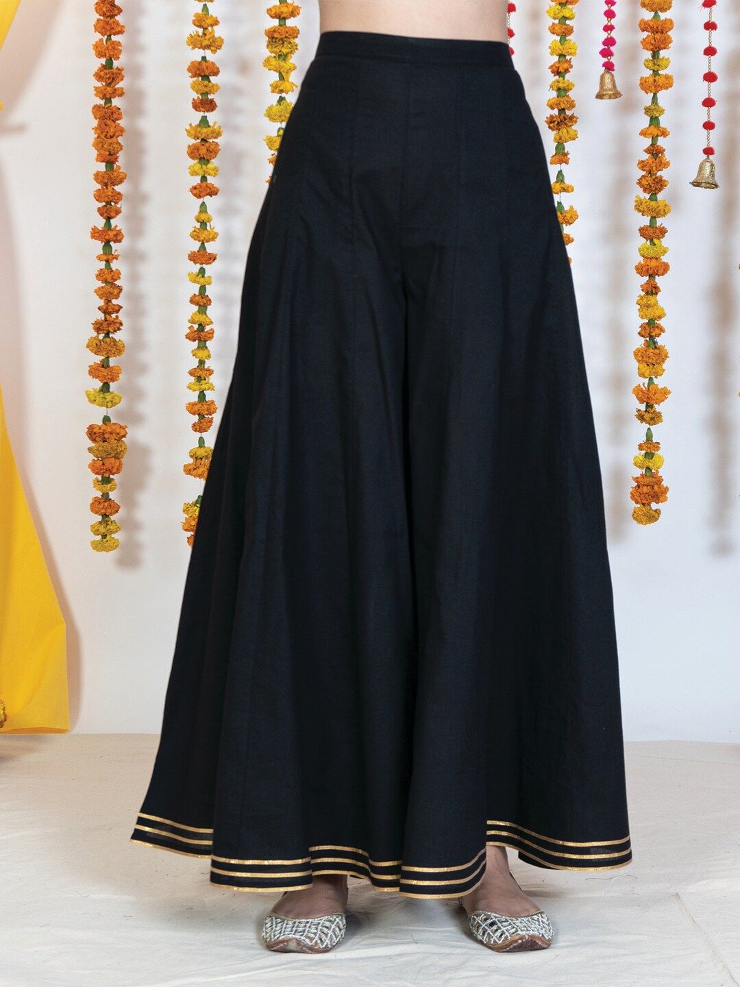 AKISO Women Black & Gold-Toned Flared Ethnic Palazzos Price in India