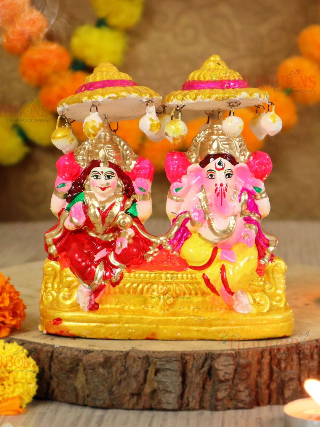 TIED RIBBONS Gold-Toned & Pink Clay Laxmi Ganesh Idol Price in India