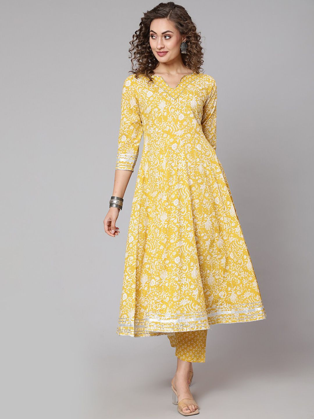 THE NKS PLUS Women Yellow Floral Printed Pleated Sequinned Pure Cotton Kurti with Trousers Price in India