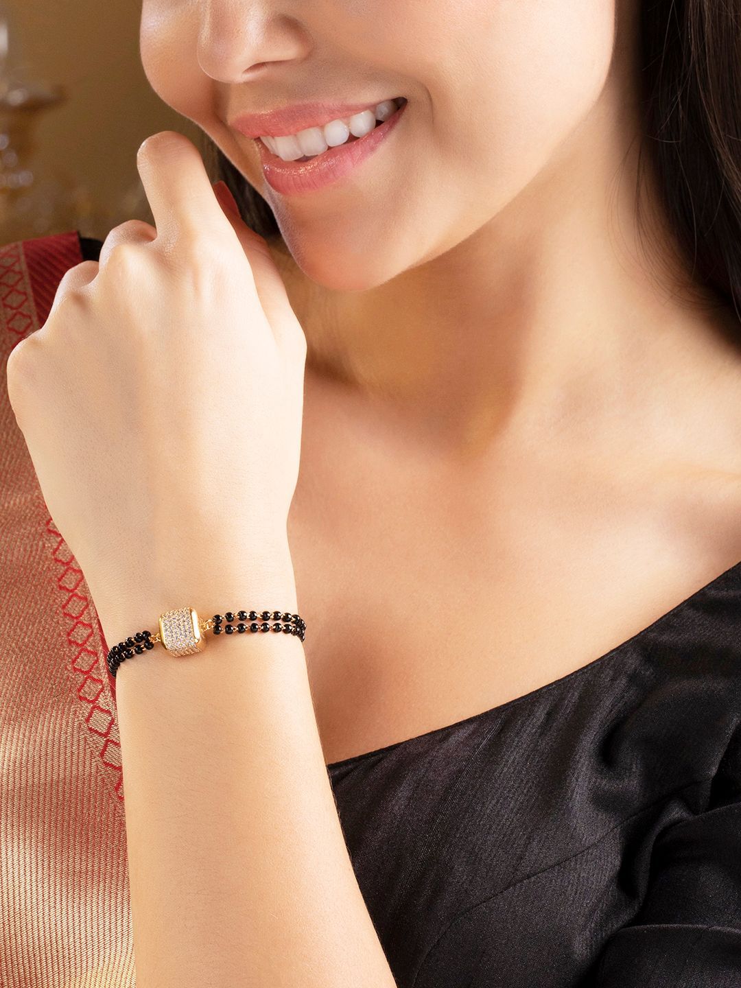 Rubans Women Gold-Plated & Black American Diamond Charm Bracelet Price in India