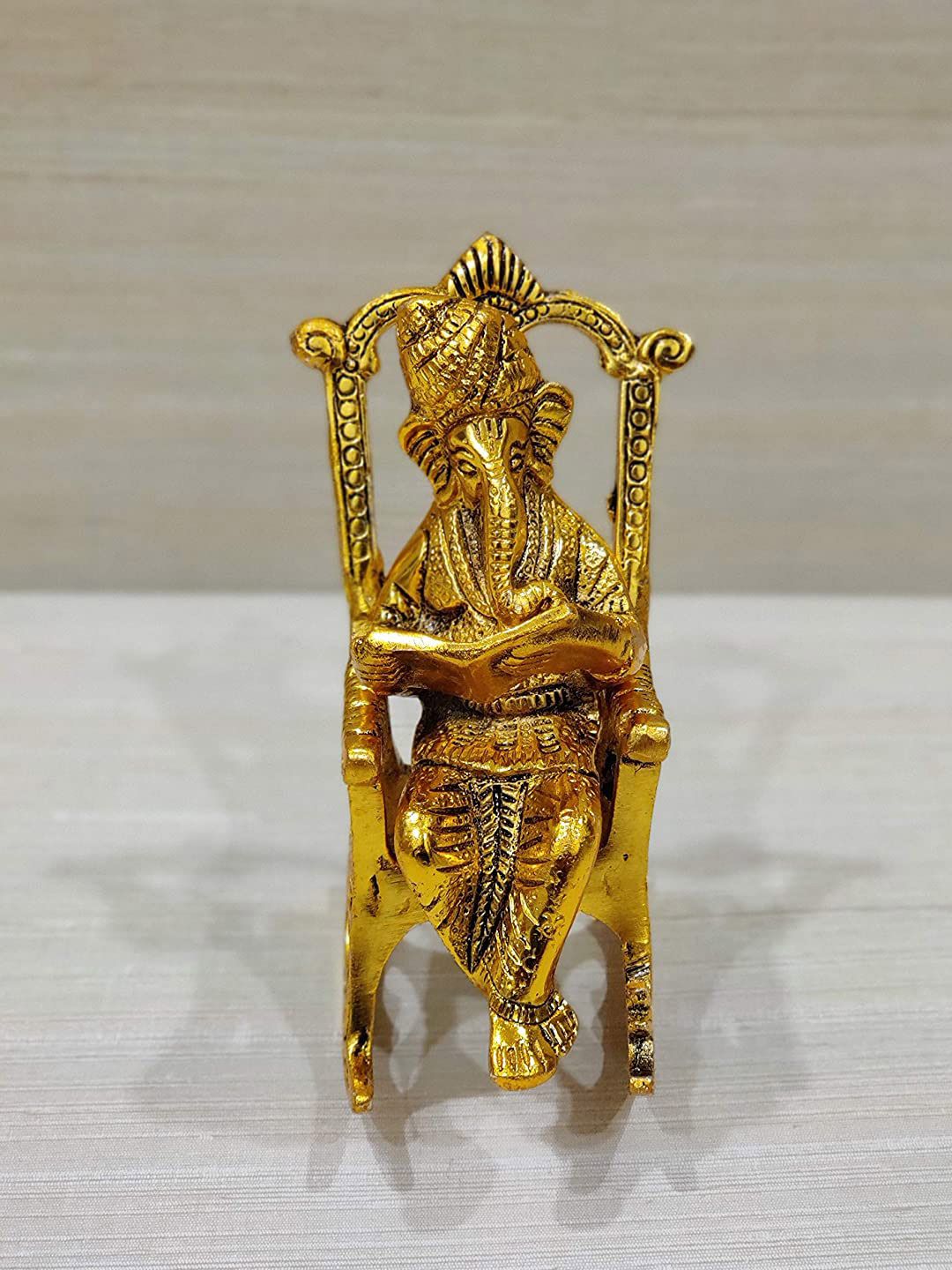 Fashion Bizz Gold-Toned Textured Metal Ganesha Statue Showpiece Price in India