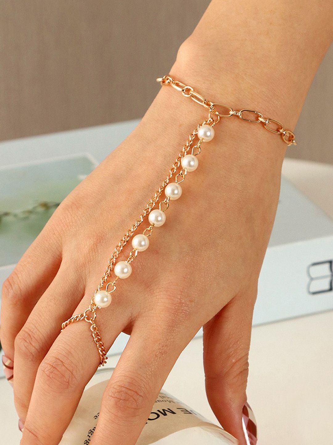 Unwind by Yellow Chimes Women Gold-Toned & White Beaded Link Hand Chain Bracelet Price in India