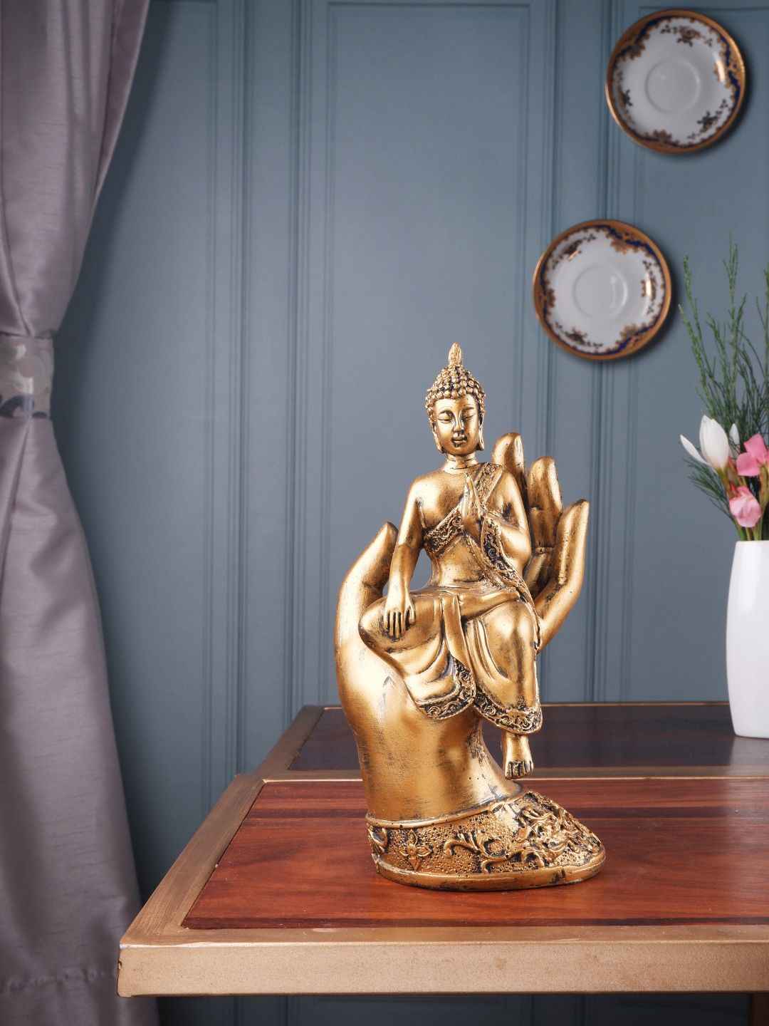 THE WHITE INK DECOR Gold-Colored Buddha Sitting on Palm Figurine Showpieces Price in India