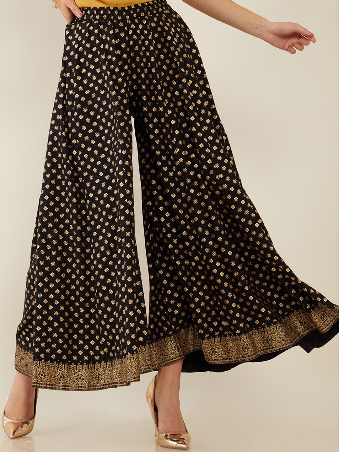 Soch Women Black & Gold-Toned Floral Printed Flared Ethnic Palazzos Price in India