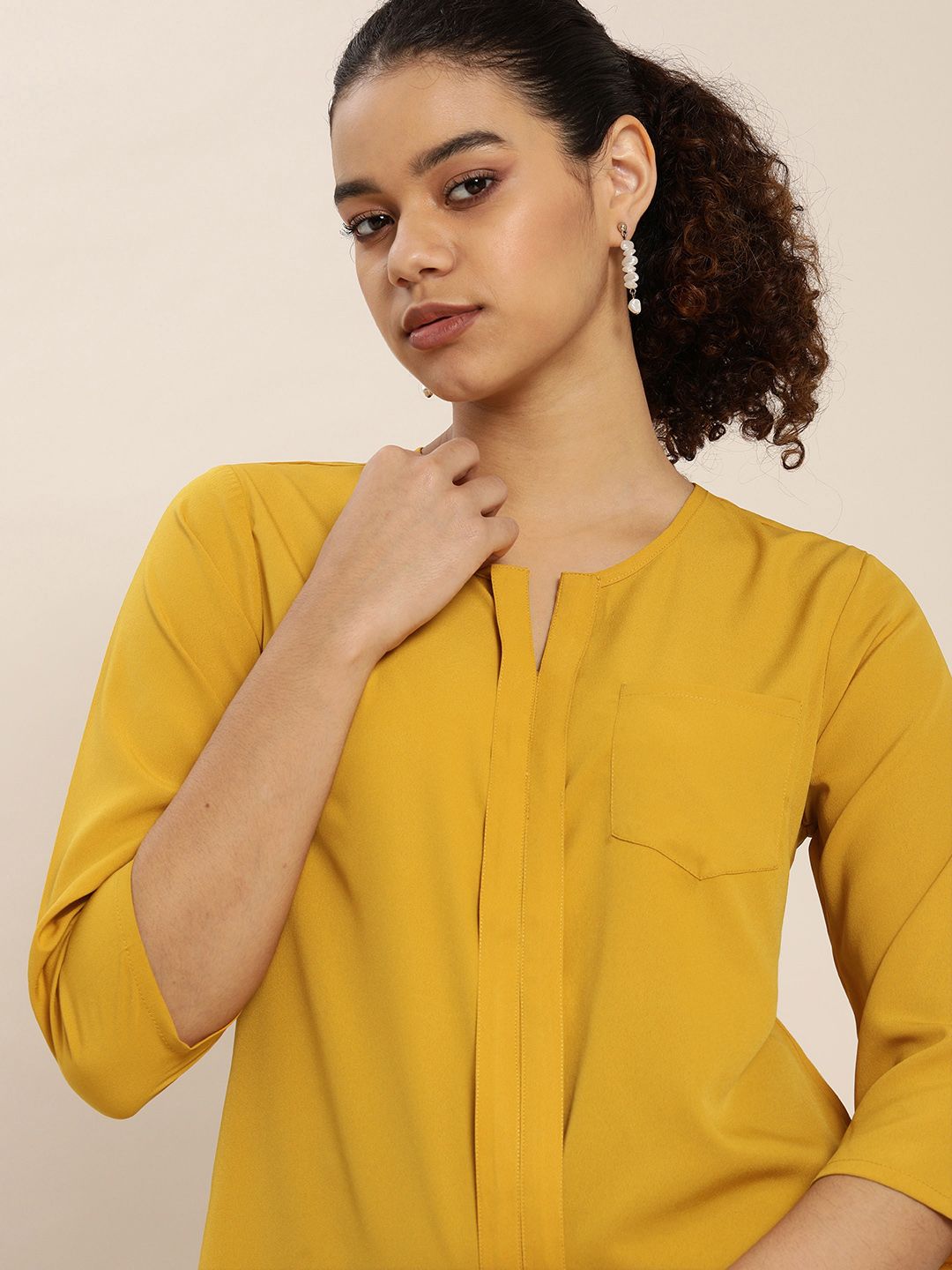 encore by INVICTUS Mustard Yellow Solid Round Neck Pocket Detailing Regular Top Price in India