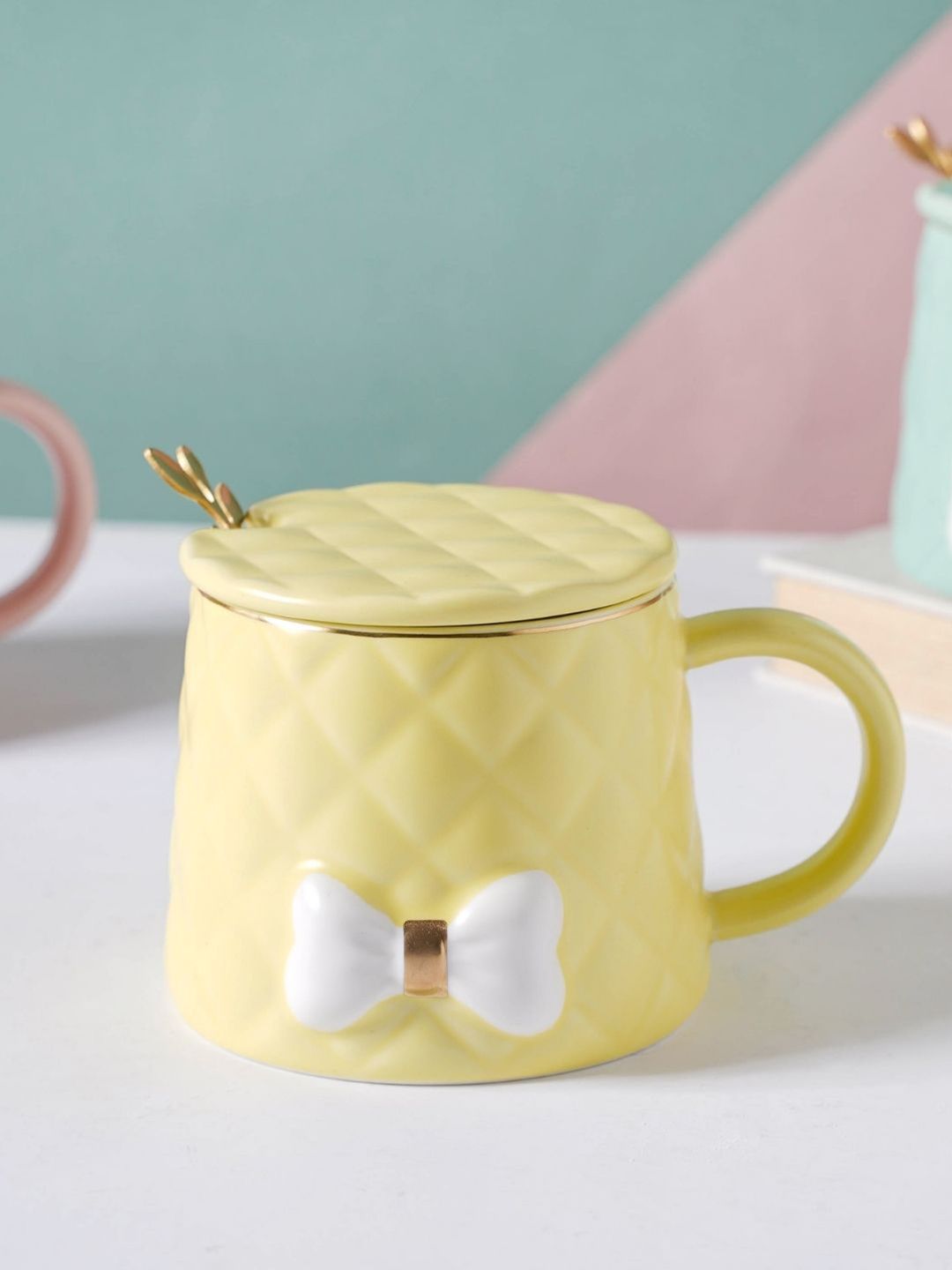 Nestasia Yellow & White Textured Ceramic Matte Bow Cup With Lid & Spoon Price in India