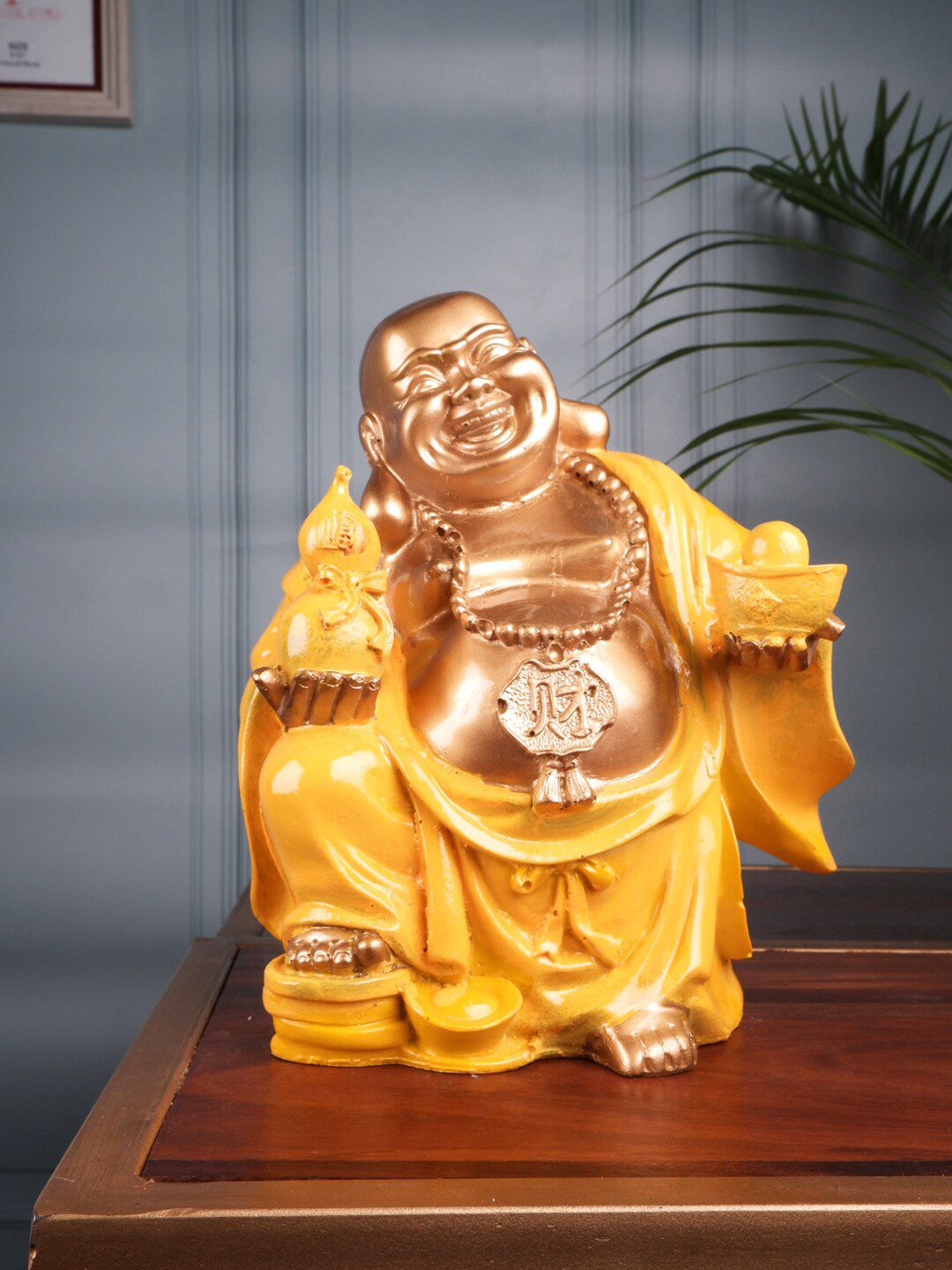 THE WHITE INK DECOR Yellow & Gold-Toned Textured Laughing Buddha Showpieces Price in India
