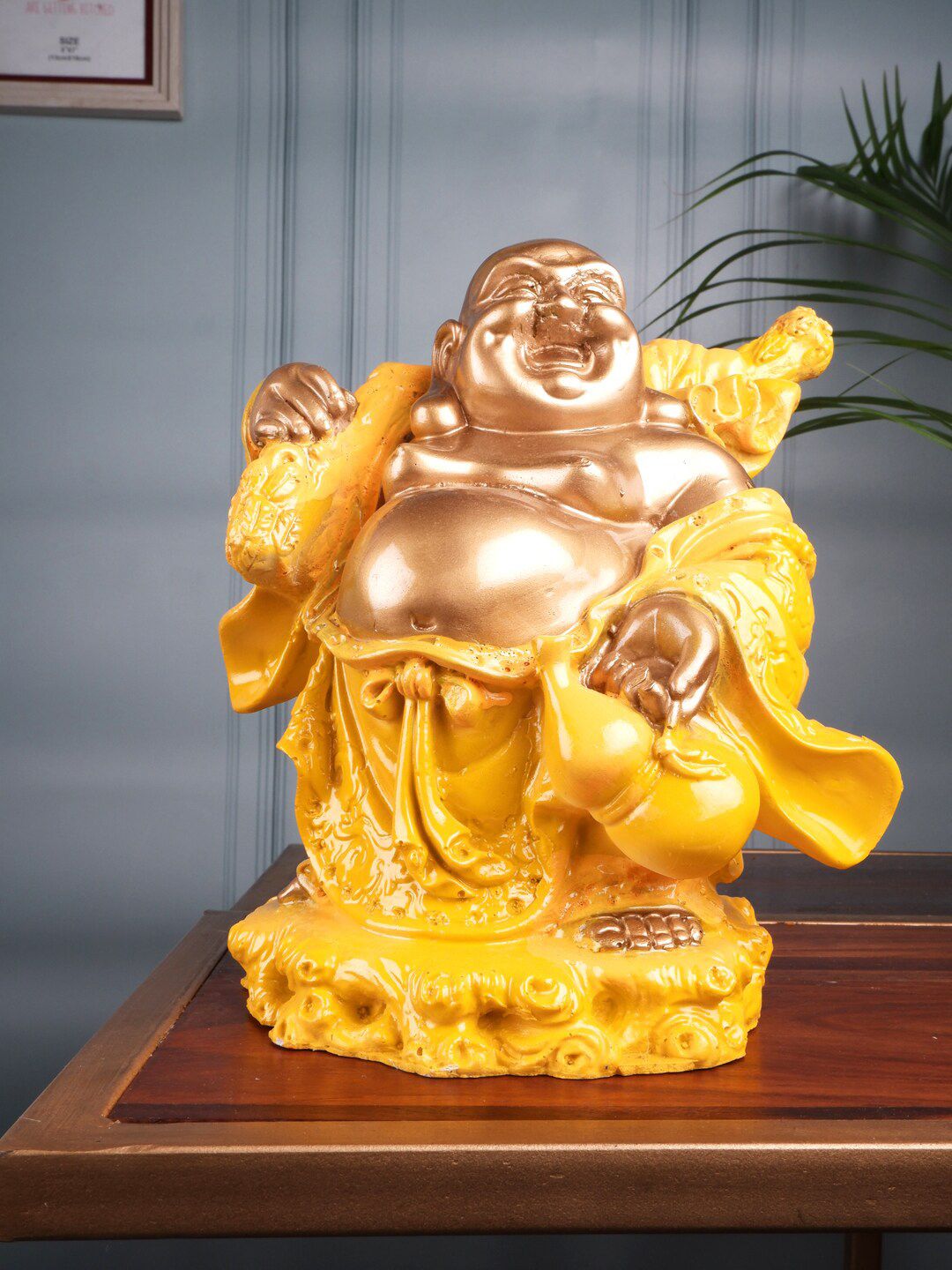 THE WHITE INK DECOR Yellow & Gold-Toned Textured Laughing Buddha Showpieces Price in India