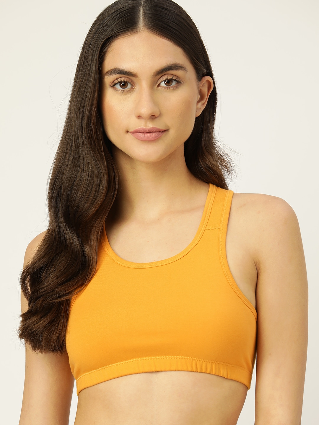DressBerry Mustard Yellow Solid Sports Bra Price in India