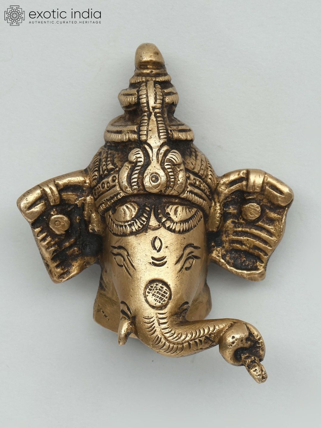 Exotic India Yellow Textured Small Lord Ganesha Face Wall Hangings