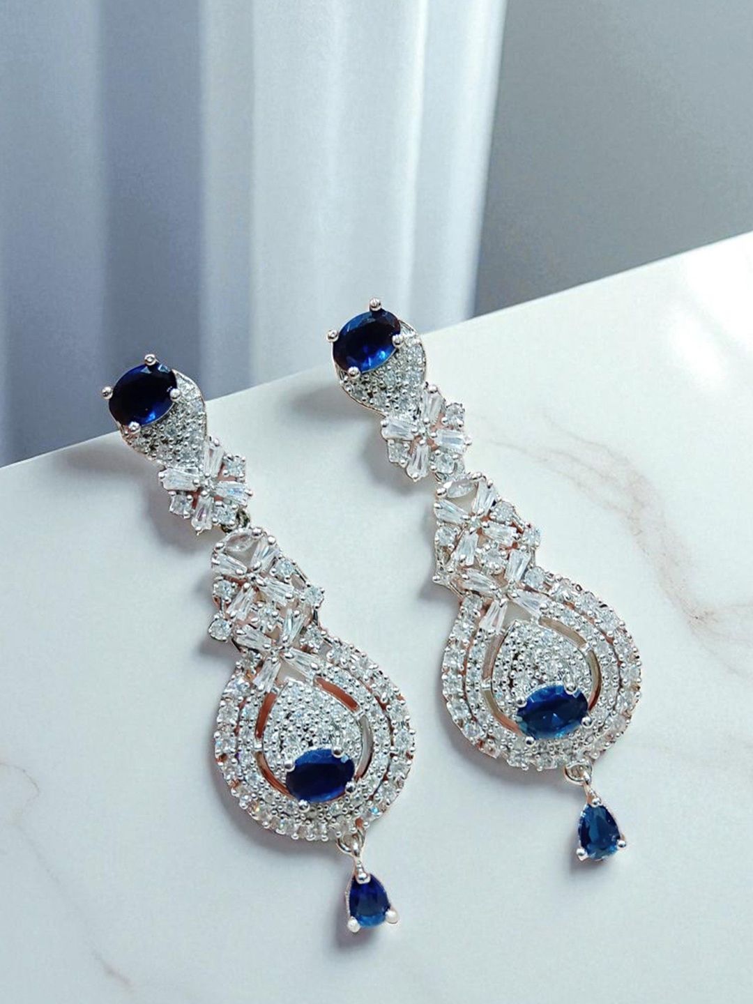 The Pari Rhodium-Plated American Diamond Studded Teardrop Shaped Drop Earrings