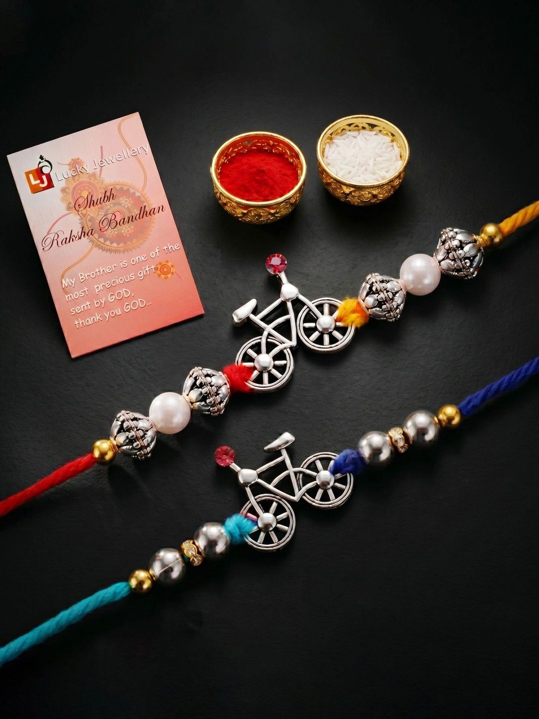 LUCKY JEWELLERY LUCKY JEWELLERY Set of 2 Silver Bicycle Rakhi with White Metallic Beads Roli Card