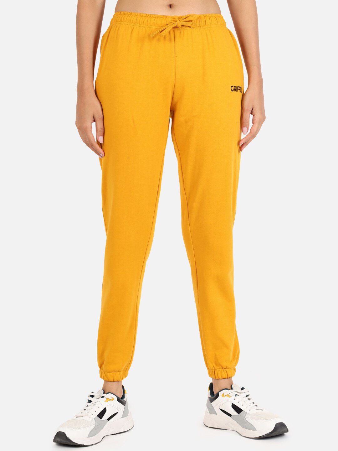 GRIFFEL Women Mustard Solid Joggers Price in India