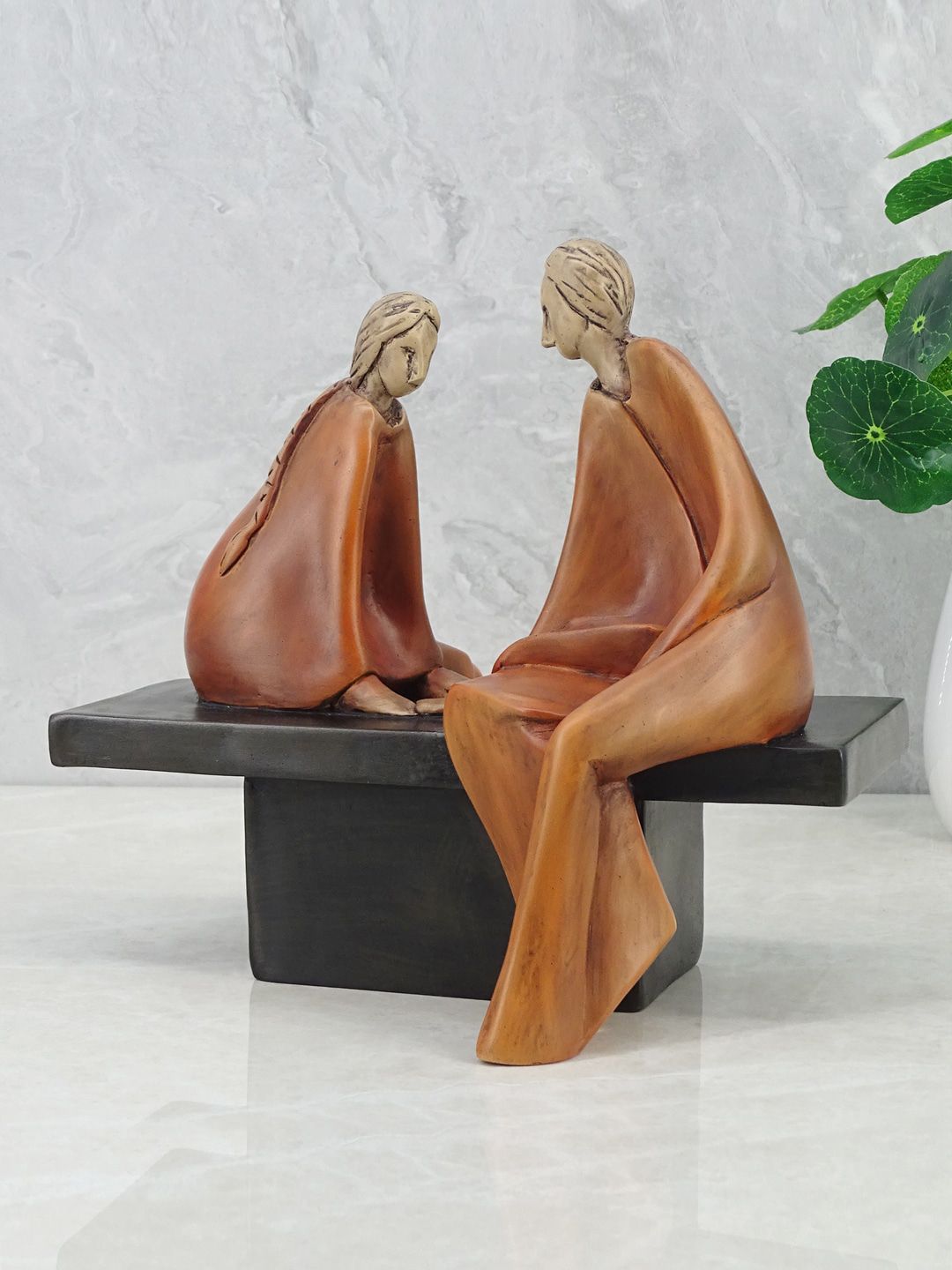 HomeTown Brown & Black Alpine Polyresin Couple Sitting On Bench Showpiece Price in India