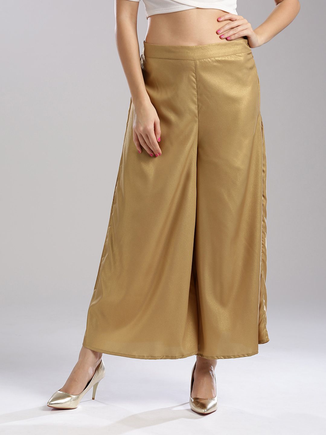 Wishful by W Women Golden Flared Solid Palazzos Price in India