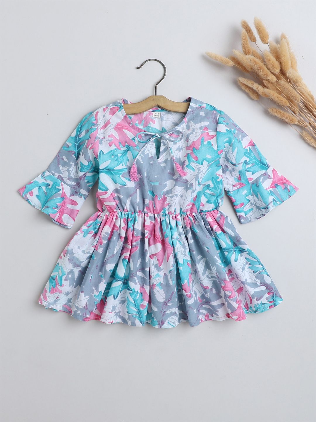 The Magic Wand Girls Floral Printed Tie-Up Neck Bell Sleeve Cotton Peplum Top