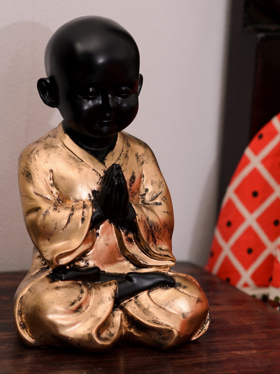 eCraftIndia Black & Gold Polyresin Praying Child Monk Figurine Price in India