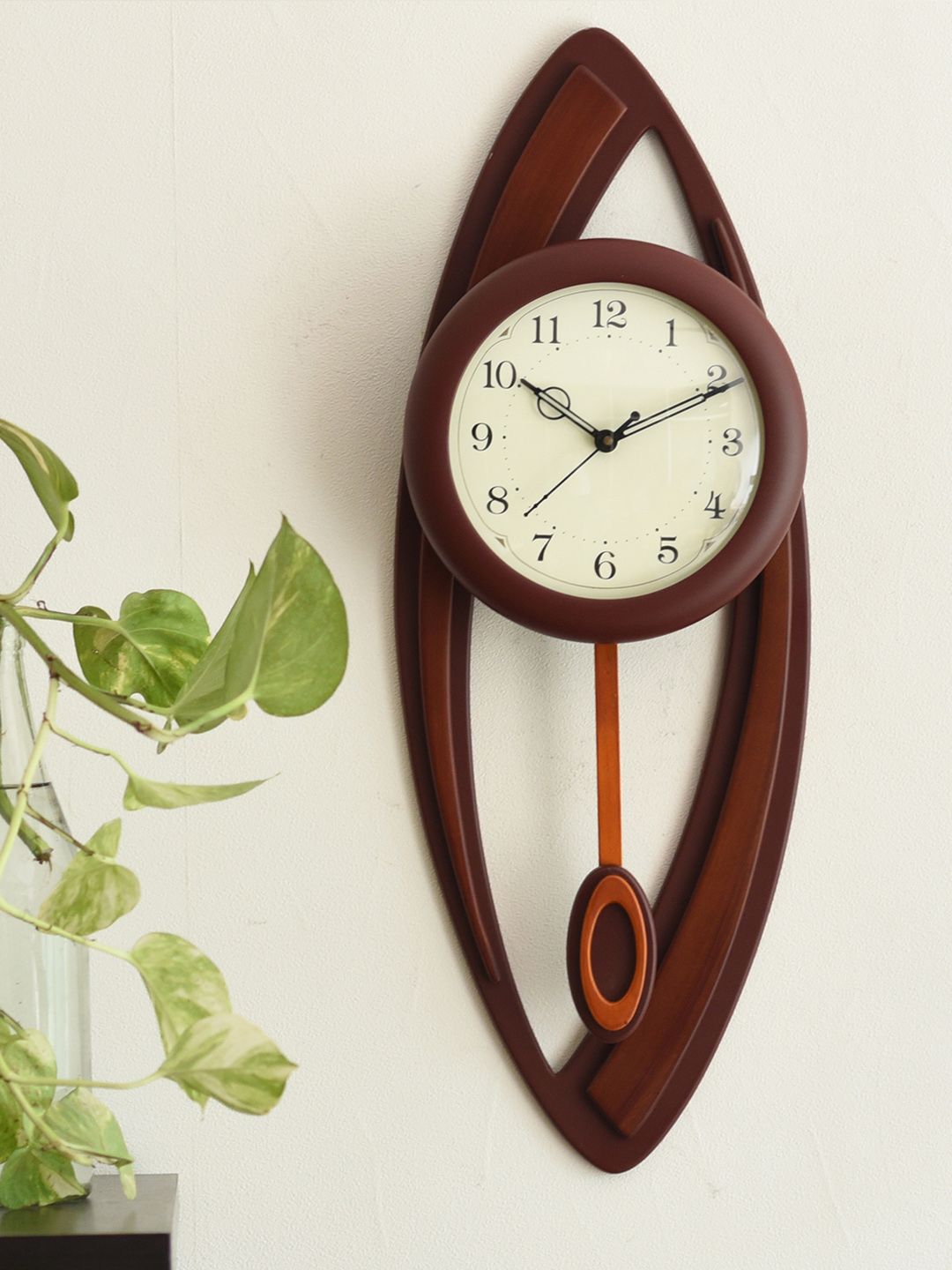 eCraftIndia Brown Handcrafted Oval Solid Analogue Wall Clock Price in India