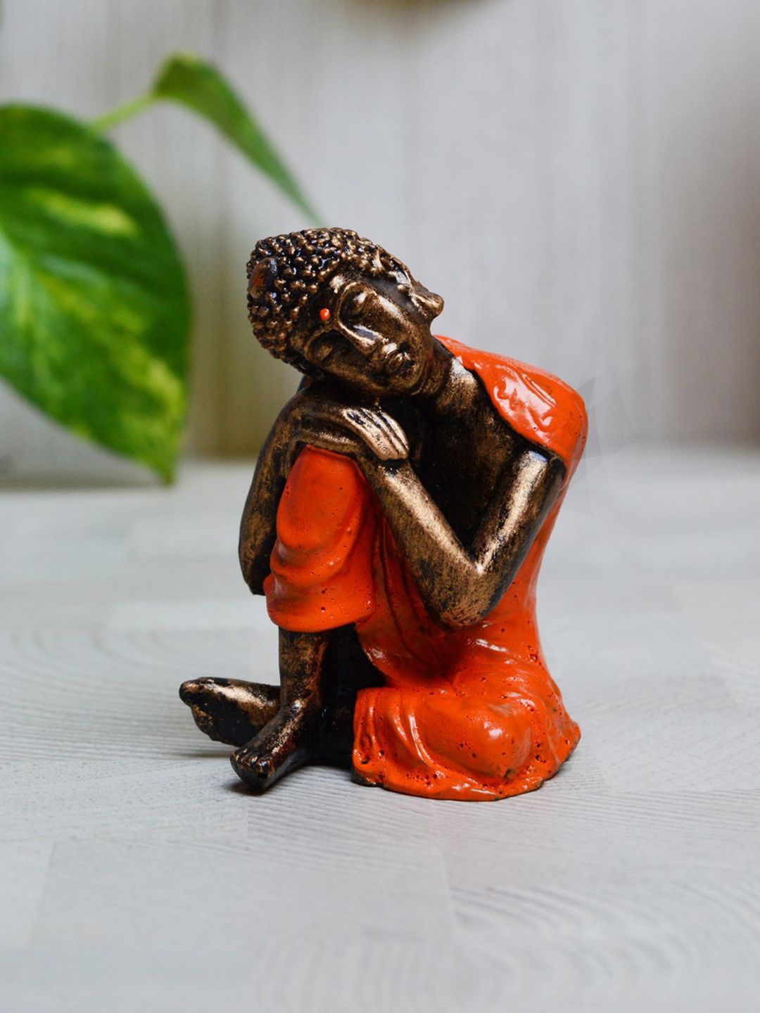 eCraftIndia Orange & Brown Polyresin Resting Buddha on Knee Showpiece Price in India