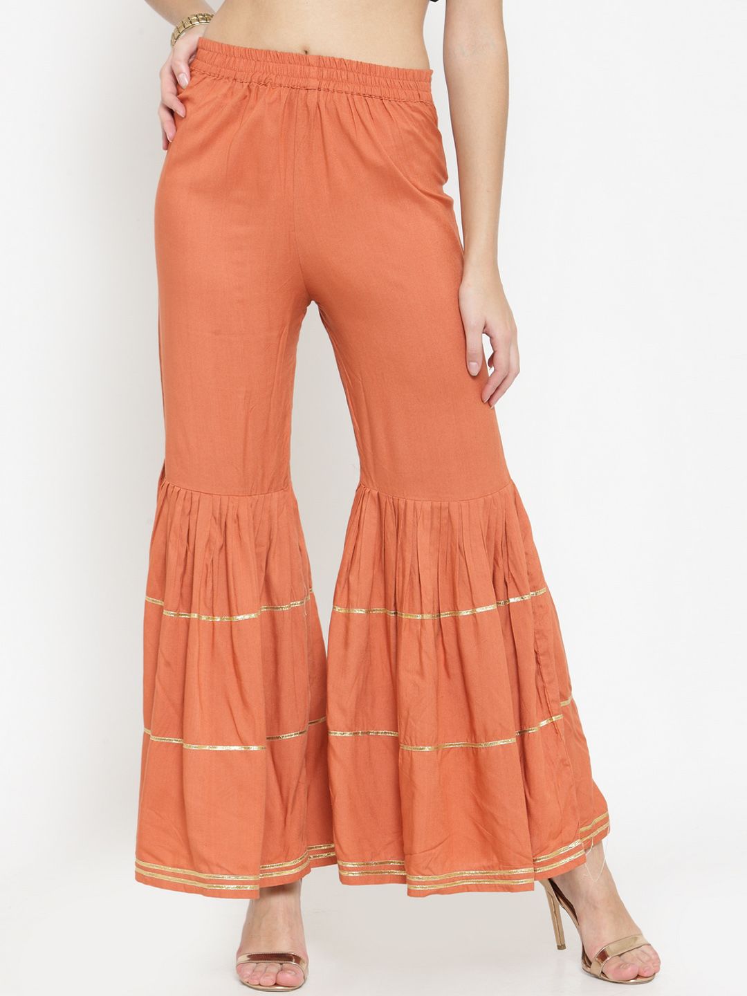 Indibelle Women Rust Orange Solid Flared Palazzos Price in India