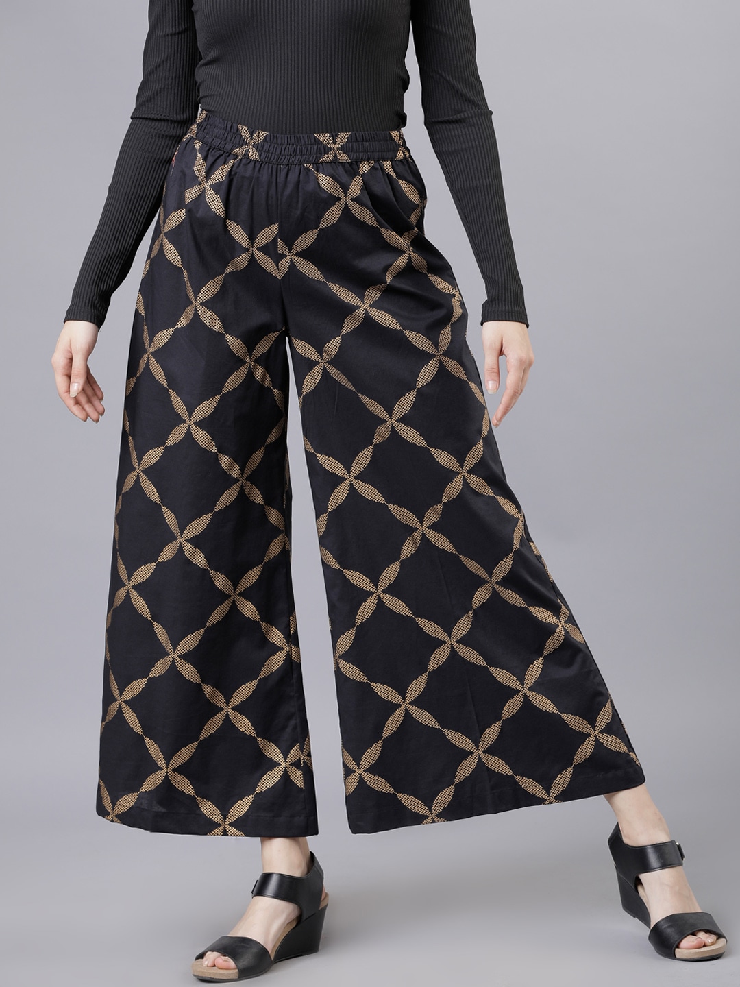 Vishudh Women Black & Gold-Toned Printed Flared Palazzos Price in India