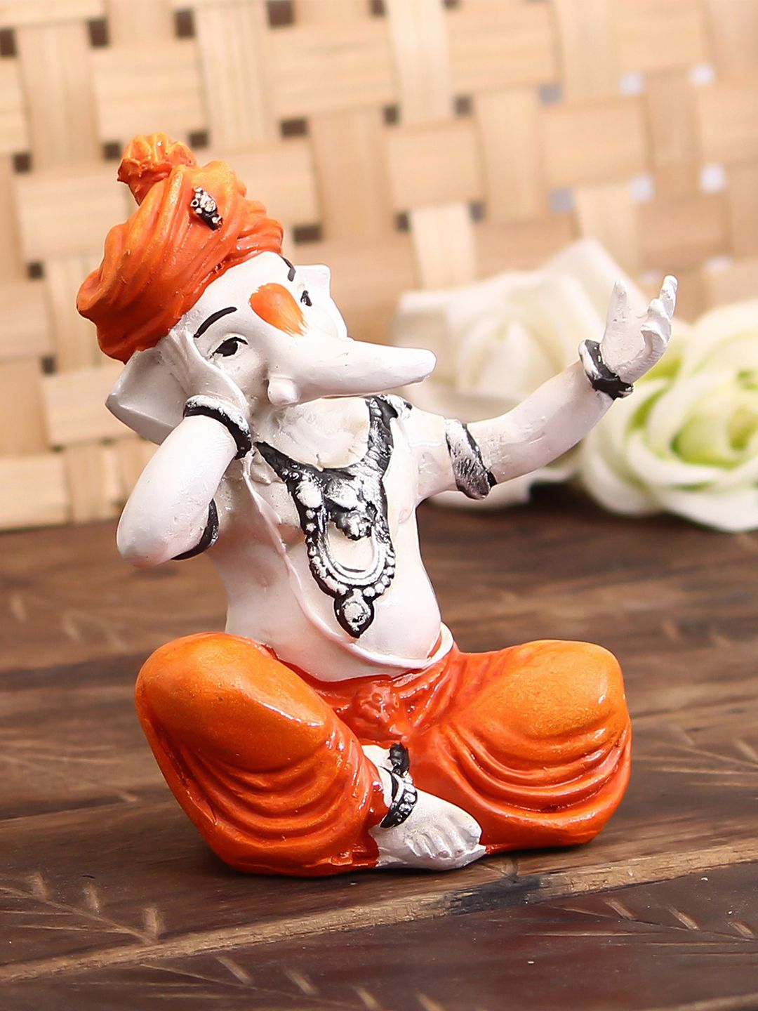 eCraftIndia Orange & Off-White Lord Ganesha Singing Showpiece Price in India
