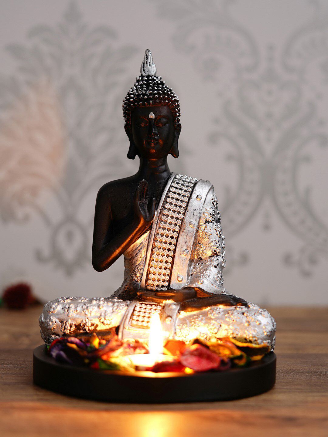 eCraftIndia Black & Silver-Toned Meditating Buddha With Wooden Base Petals & Tealight Showpiece Price in India