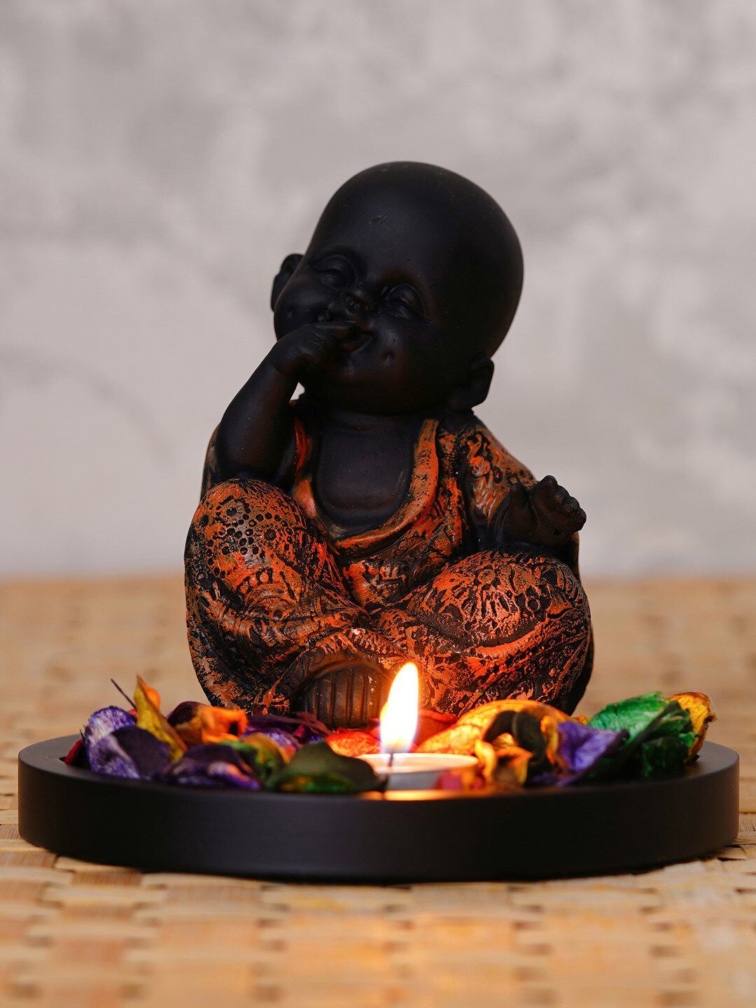 eCraftIndia Brown & Black Decorative Smiling Monk Buddha With Wooden Base Fragranced Petals & Tealight Showpiece Price in India