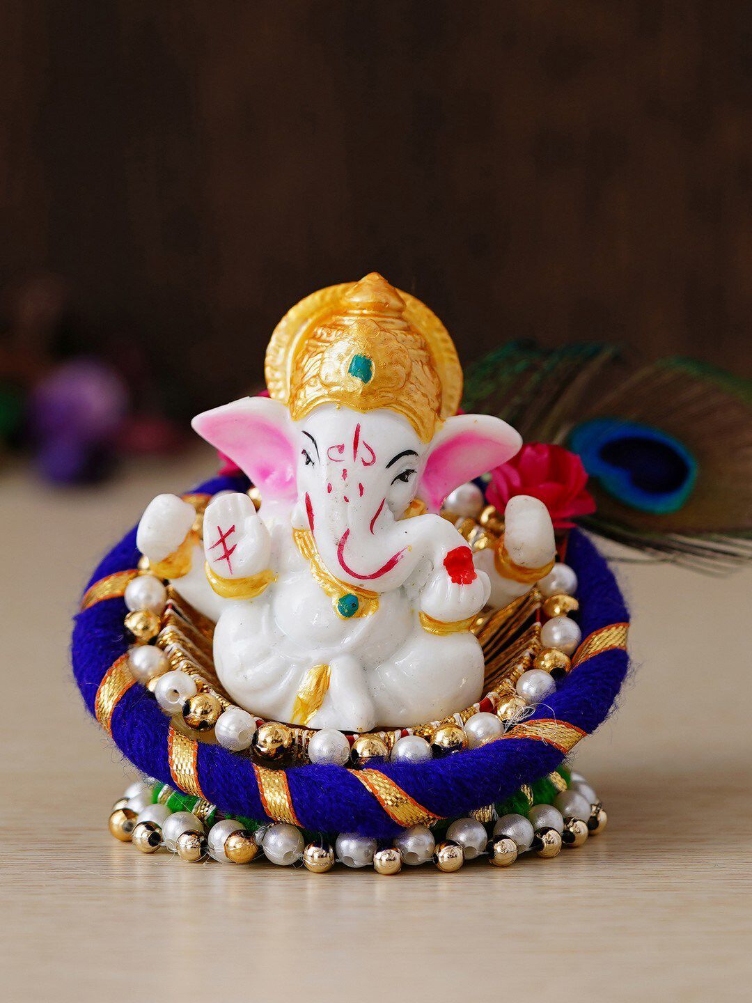 eCraftIndia Blue & White Handcrafted Lord Ganesha Idol on Floral Plate with Peacock Feather Decorative Showpiece Price in India