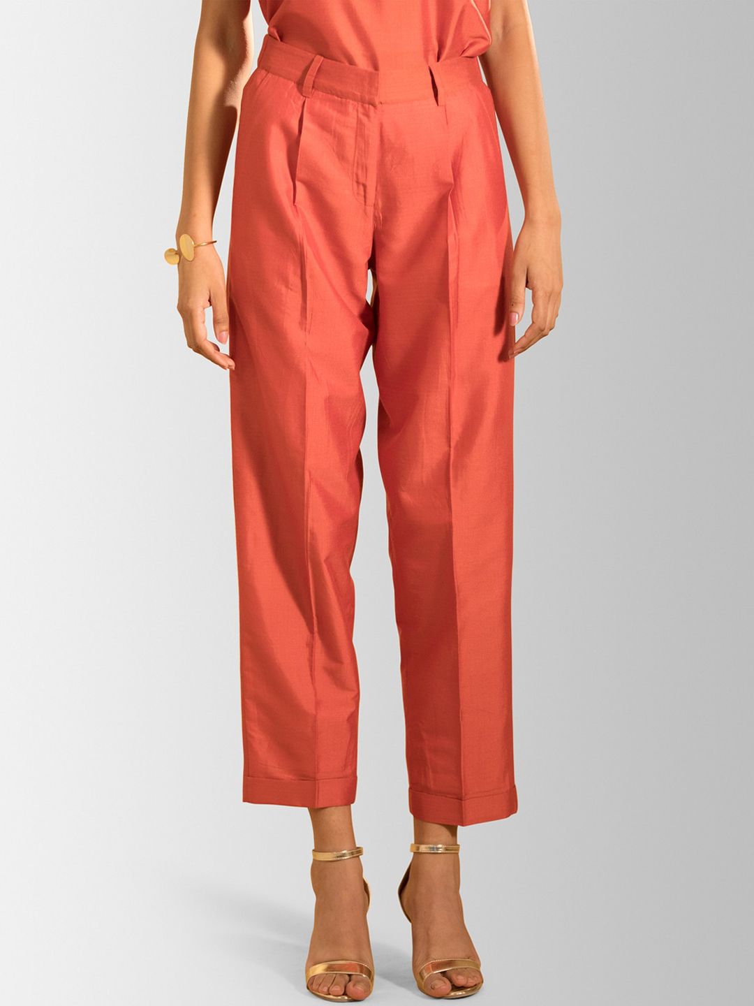 FableStreet Women Rust Orange Regular Fit Solid Parallel Trousers Price in India