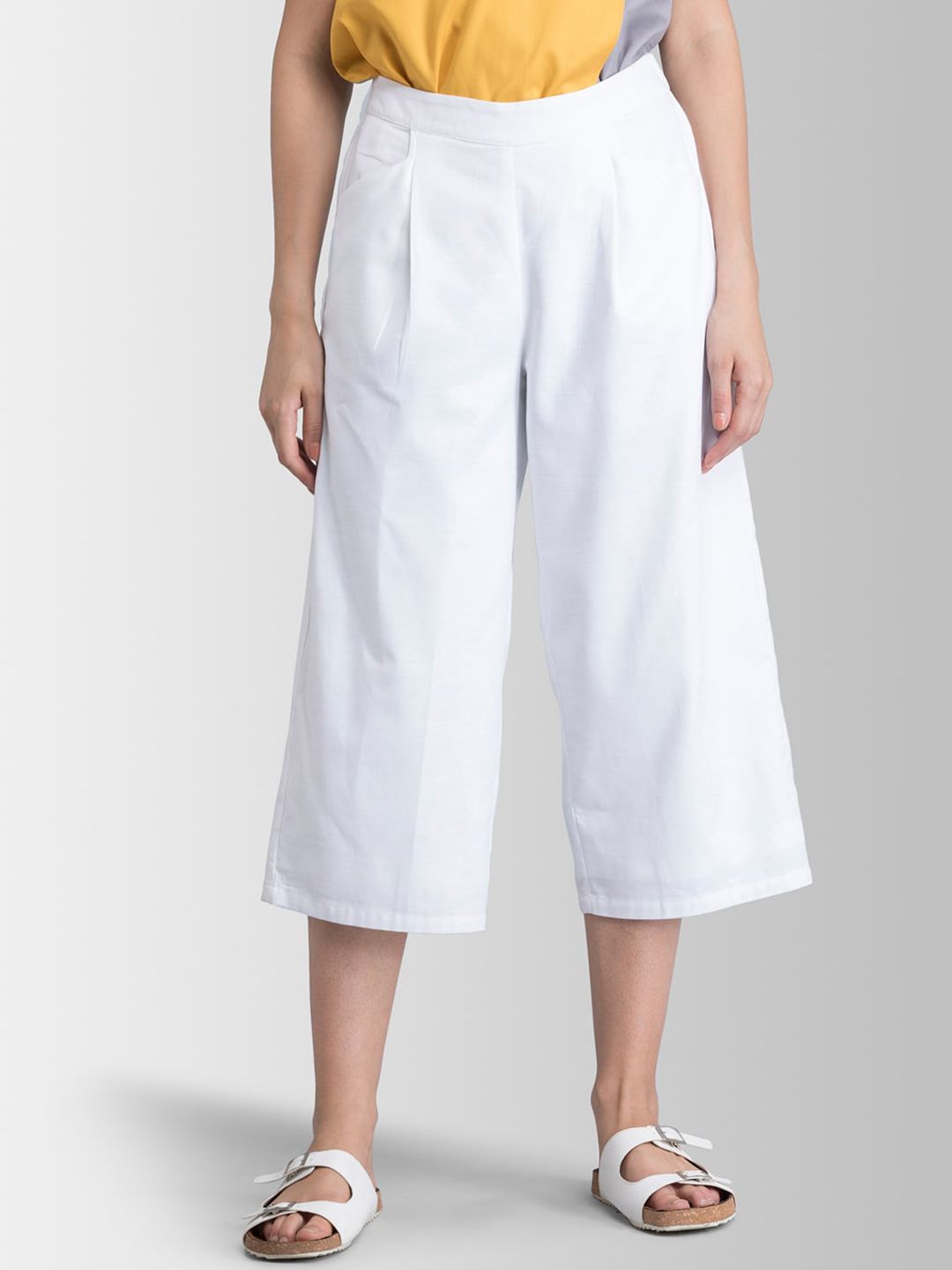 FableStreet Women White Loose Fit Solid Regular Trousers Price in India