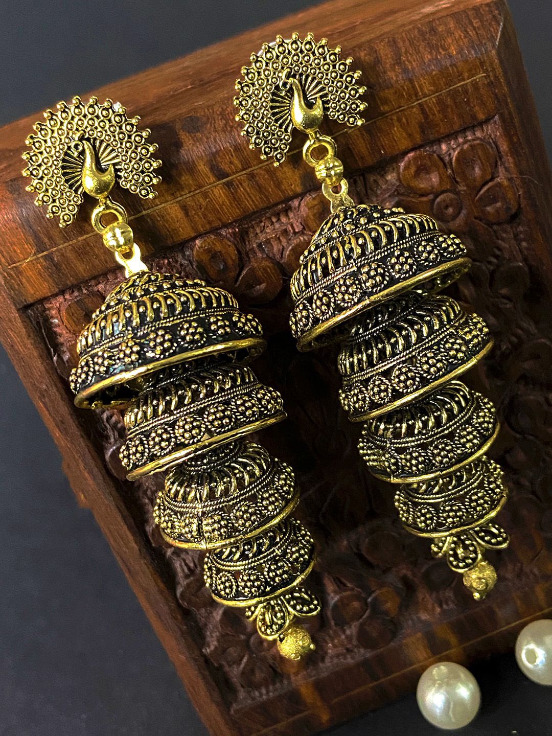 ANIKAS CREATION Gold plated Peacock Shaped Antique Jhumkas Price in India
