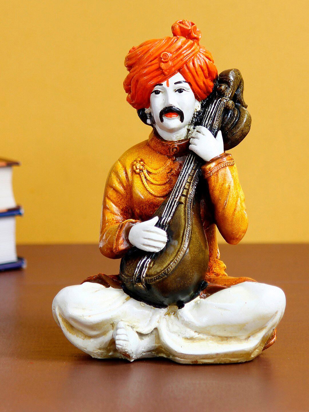 eCraftIndia Orange Rajasthani Musician Playing Sitar Handcrafted Decorative Polyresin Showpiece Price in India