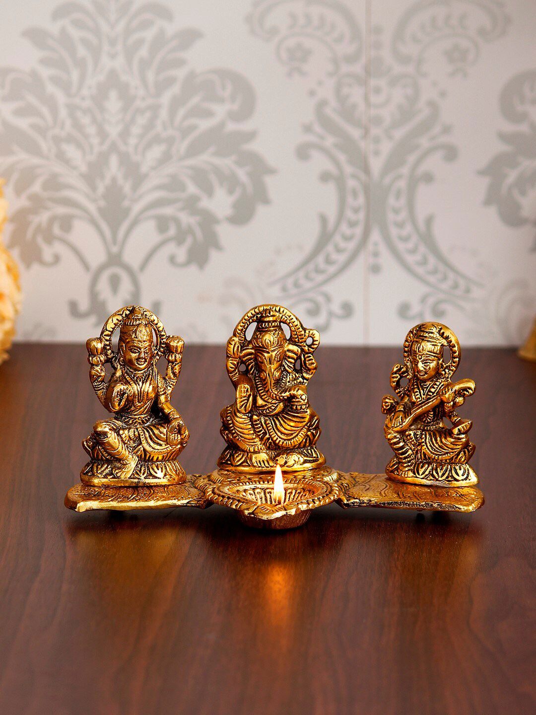 eCraftIndia Gold-Toned Laxmi Ganesha With Diya On Leaf Chowki Handcrafted Metal Decorative Showpiece Price in India