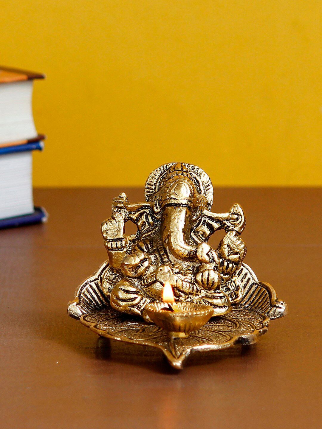 eCraftIndia Gold-Toned Lord Ganesha With Diya On Leaf Handcrafted Metal Showpiece Price in India