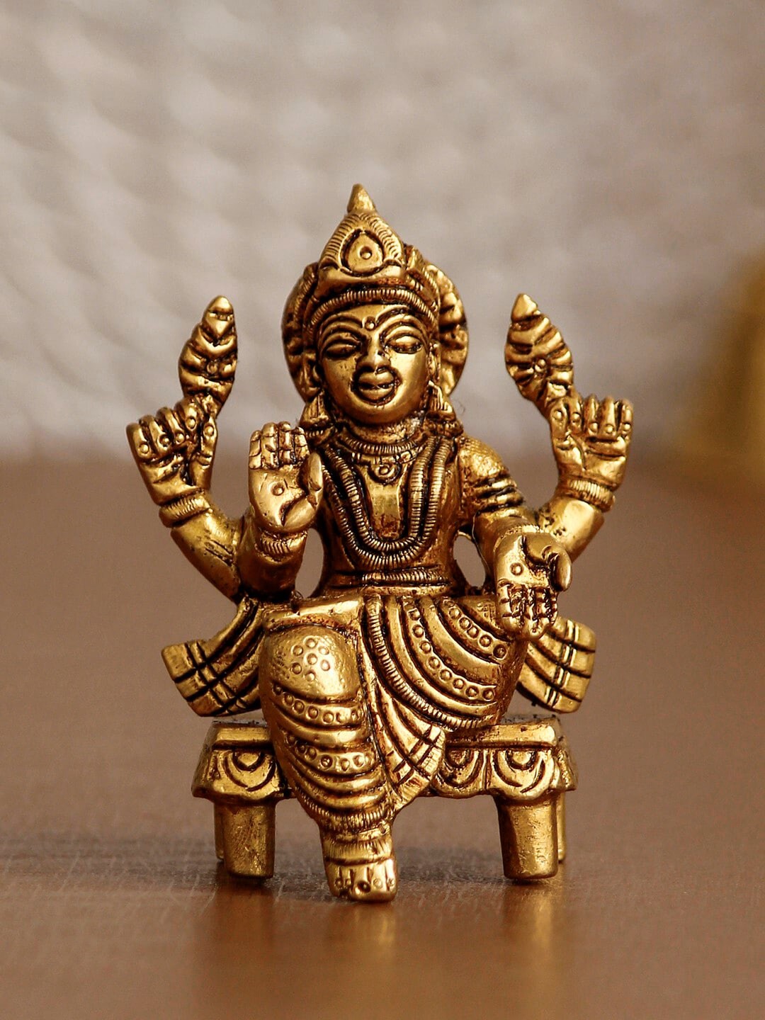 eCraftIndia Oxidised Gold-Toned Goddess Laxmi On Chowki Handcrafted Brass Idol Showpiece Price in India