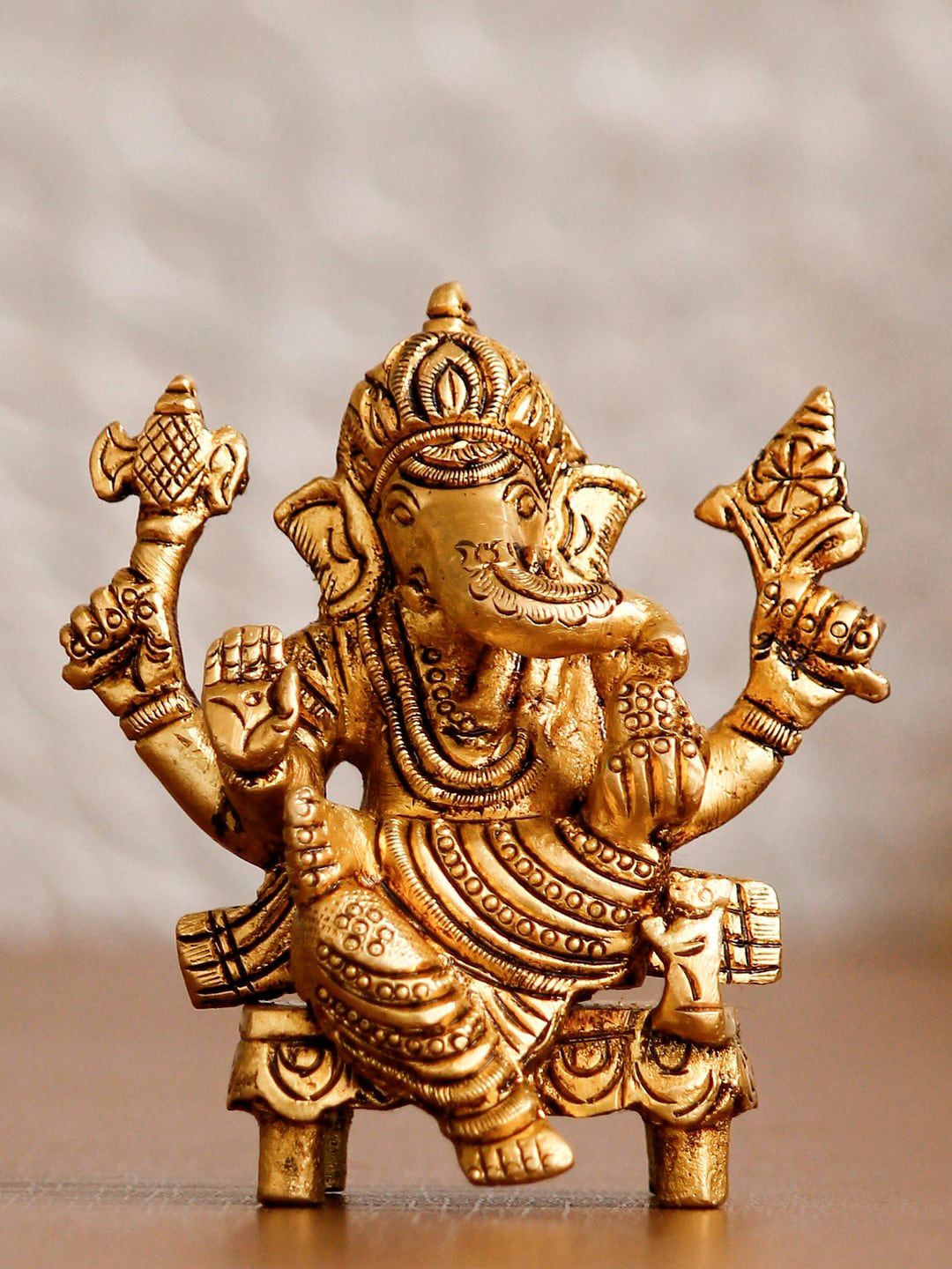eCraftIndia Gold-Toned 4 Bhujadhari Lord Ganesha on Chowki Handcrafted Idol Showpiece Price in India