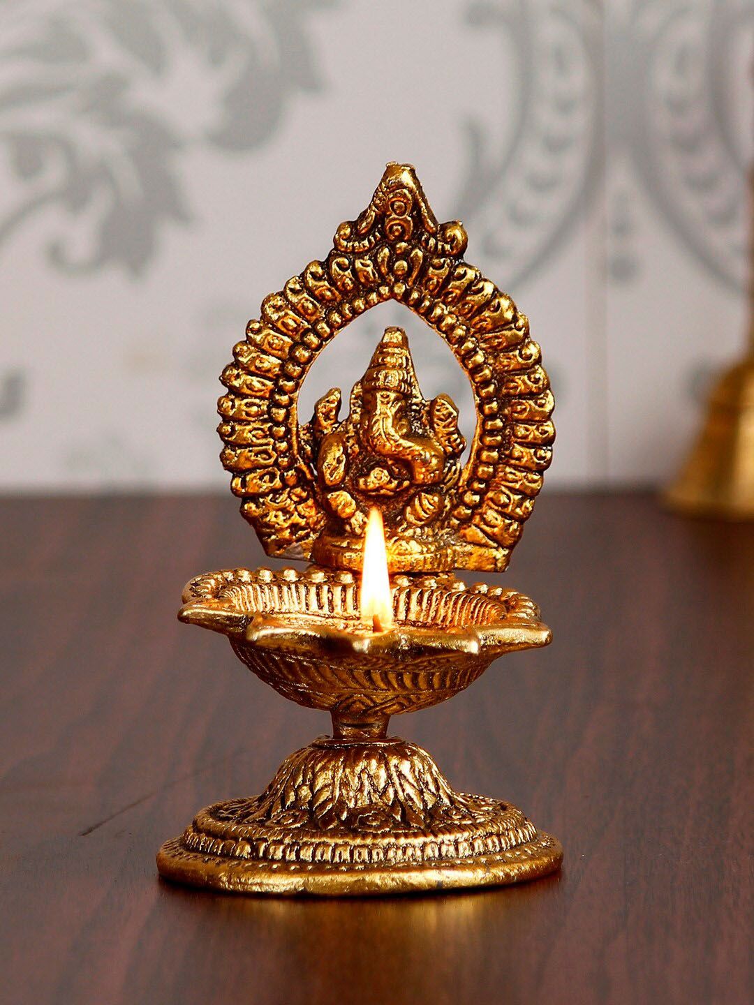 eCraftIndia Gold-Toned Lord Ganesha With Diya Handcrafted Showpiece Price in India