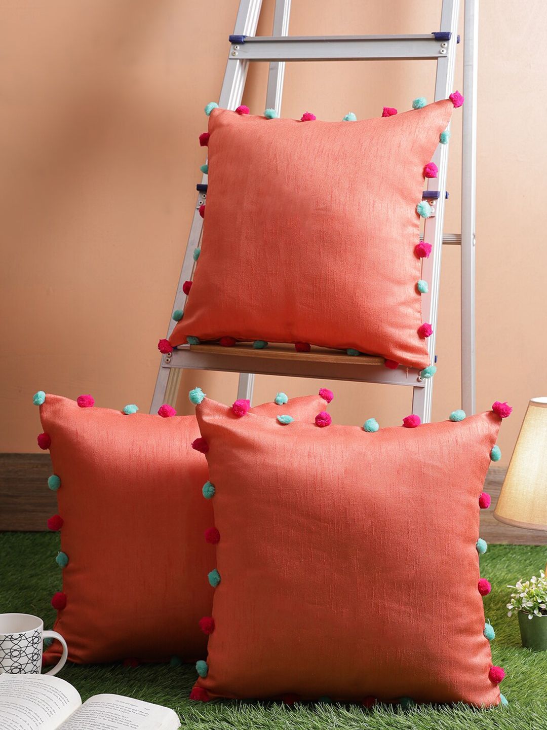 RANGDESI Orange Set of 3 Embellished Silk Cushion Cover With Pom Pom Balls Price in India